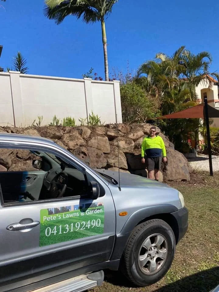 Pete beside the branded Pete's M Lawn and Garden vehicle