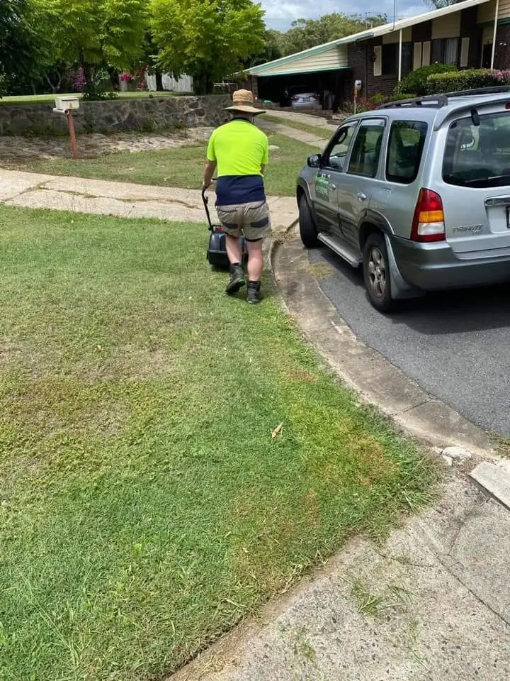 Pete mowing a suburban lawn in Molendinar
