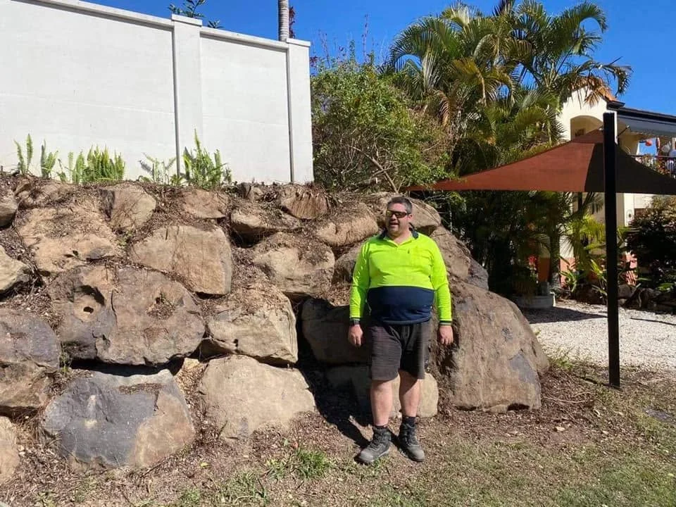 Pete beside a large rock garden feature, Molendinar